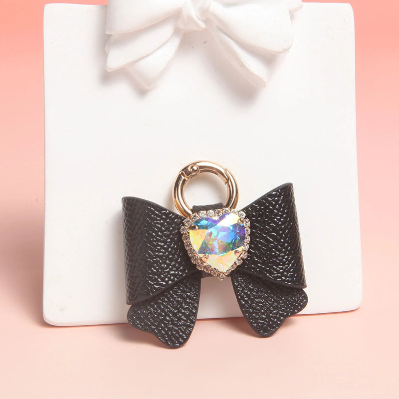 Black leather butterfly bow charm with gold ring and heart rhinestone