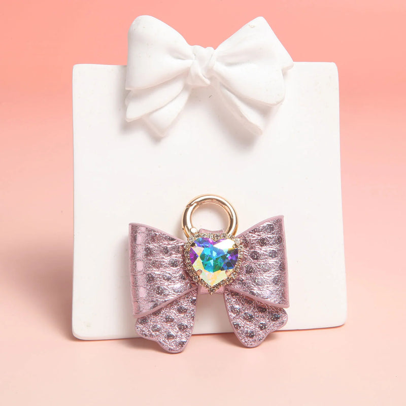 Pink metallic leather butterfly bow charm with gold ring and heart rhinestone