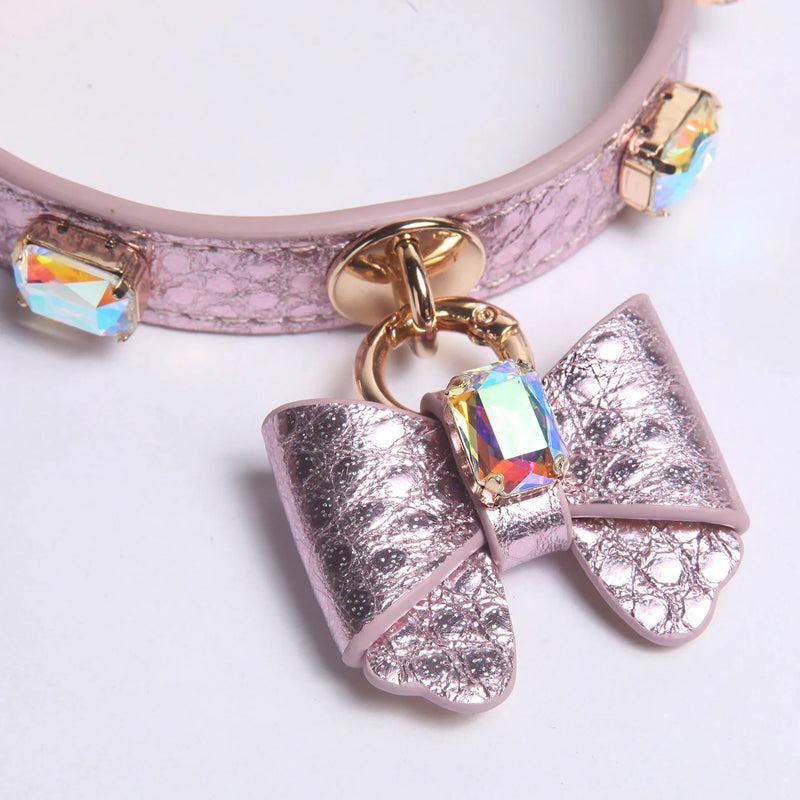 Small dog wearing purple AB crystal butterfly bow leather collar