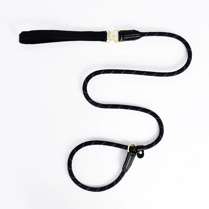A black rope dog slip lead leash with subtle blue and white patterns, featuring gold-toned brass hardware and a reinforced black leather handle attachment on a white background.