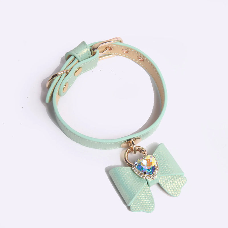 Side view of bow charm collar showing adjustable buckle and D-ring for leash attachment