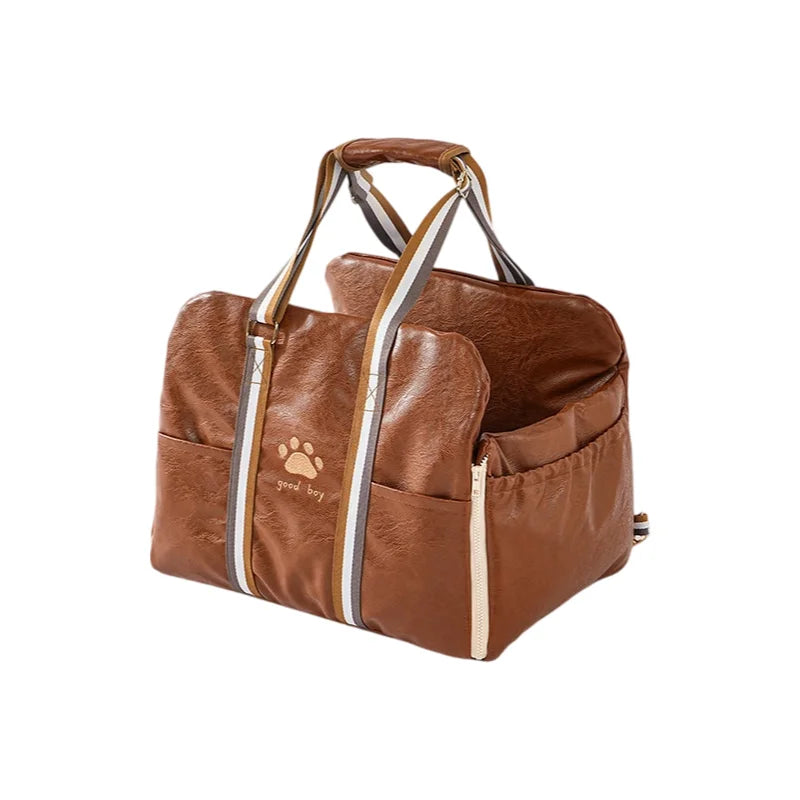 Brown faux leather pet carrier with paw print and good boy text detail