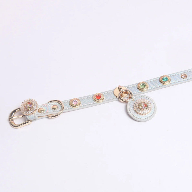 Close-up of iridescent leather collar with colorful gem stones in pink red green and mint