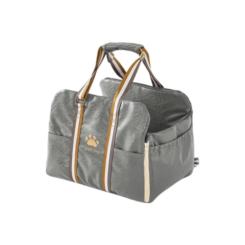 Grey fabric pet carrier with brown and white striped handles and paw print detail