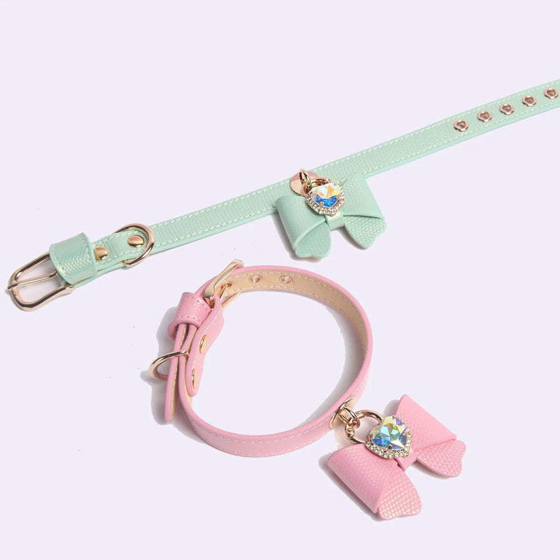 Heart-shaped iridescent AB rhinestone pendant detail on mint green bow collar