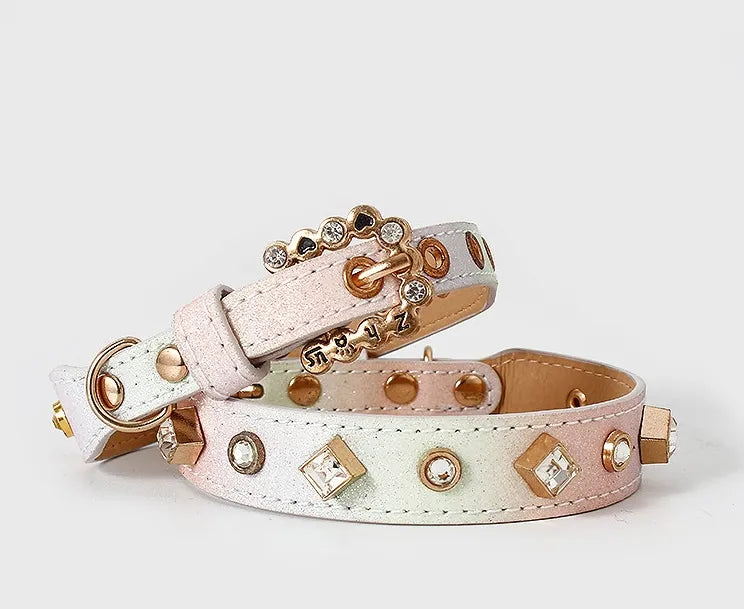 An iridescent pastel ombre pet collar featuring shimmering pink and blue hues, adorned with gold rhinestone studs and a decorative jeweled buckle against a plain white background.