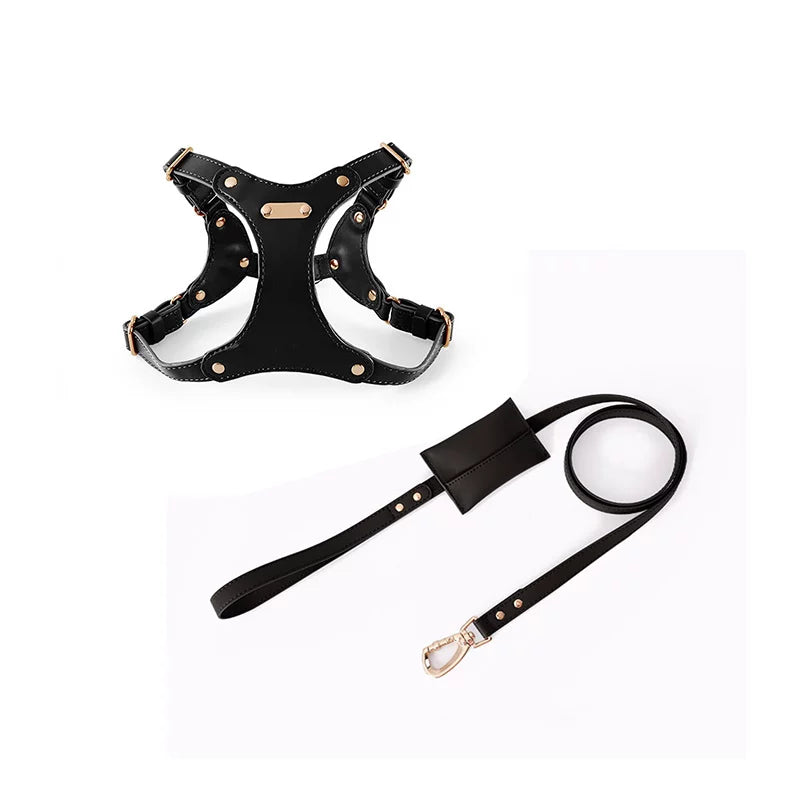 A premium black eco-leather dog harness and matching leash set featuring stylish gold-toned hardware and an integrated waste bag dispenser on a plain white background.