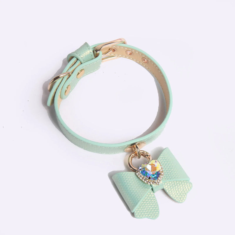 Mint green butterfly bow leather pet collar with rose-gold hardware on pale background