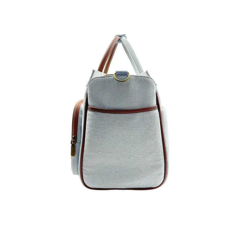 Gray canvas pet carrier backpack with brown leather trim, D-ring and side pocket