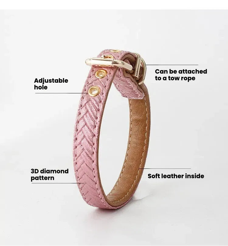 A pink leather dog collar featuring a textured 3D diamond pattern, gold-tone adjustable grommet holes, and a soft brown leather interior lining against a plain white background.