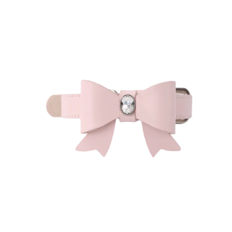 A delicate light pink pet collar featuring a large, layered bow adorned with a sparkling oval crystal centerpiece on a black background.