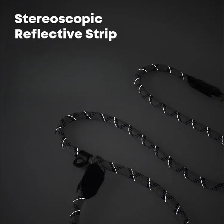 A close-up view of a dark braided rope dog leash with glowing white reflective strips spiraling around it, set against a dark background to demonstrate its high visibility for night safety.