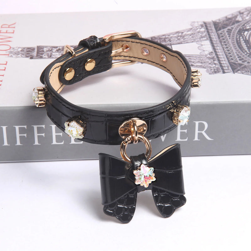 Dog wearing black snowflake crystal bow collar with silver-tone hardware