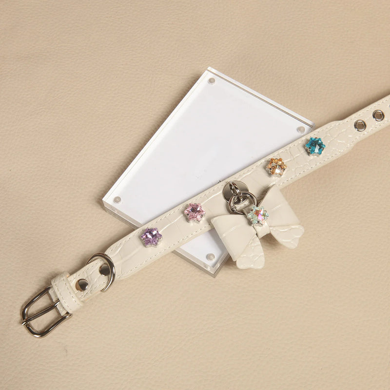 Snowflake bow leather collar color options: black, pink, and white variants