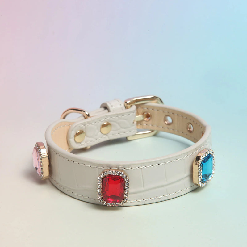 Dog wearing white square crystal collar showing side view with gold buckle detail