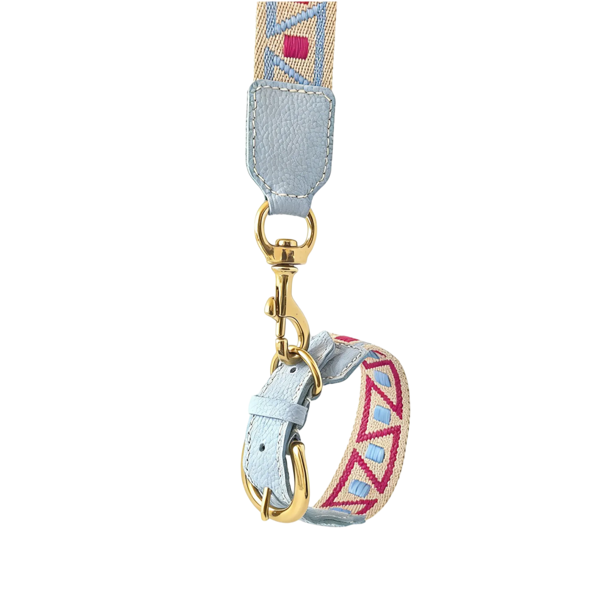 Close-up view of an artisan woven dog leash featuring light blue pebbled leather accents, a geometric pattern in beige, blue, and pink, and polished gold hardware against a black background.